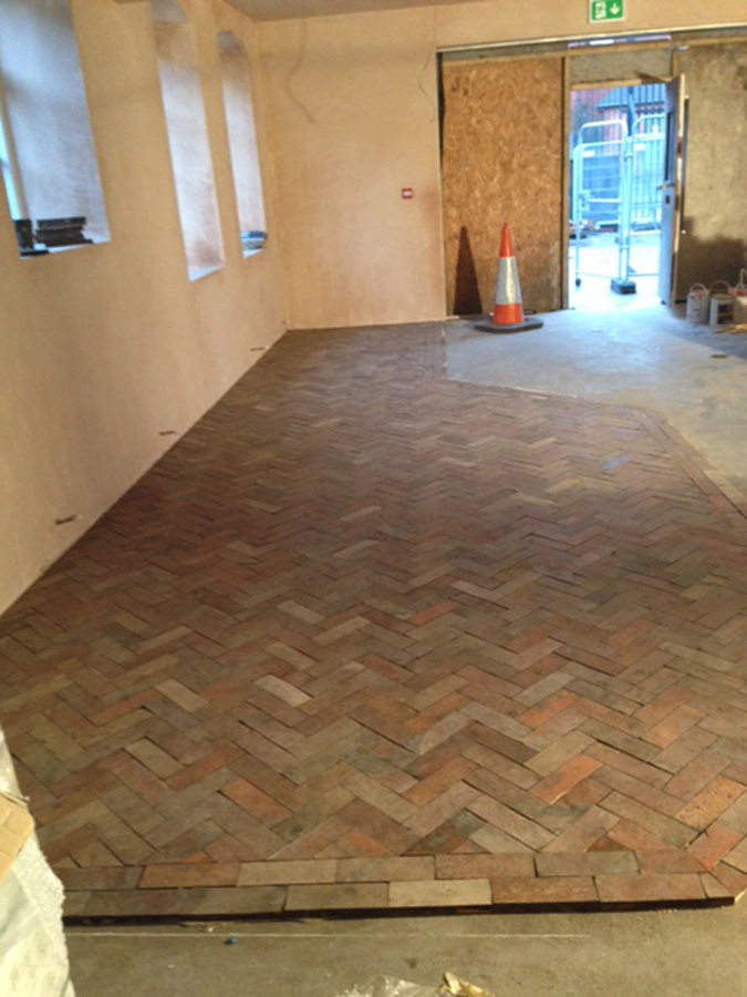 The reclaimed floor starts to be laid at The Glost House